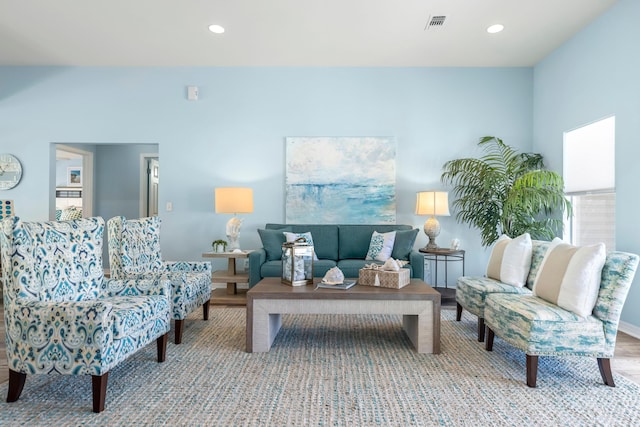 living area with visible vents, wood finished floors, and recessed lighting