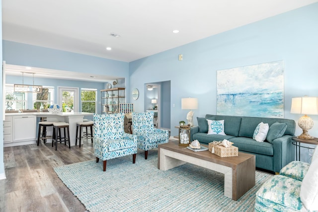 living room featuring recessed lighting, visible vents, and light wood-style flooring