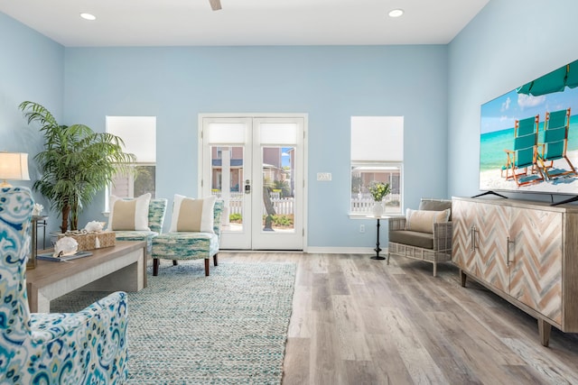 sitting room featuring recessed lighting, french doors, baseboards, and wood finished floors