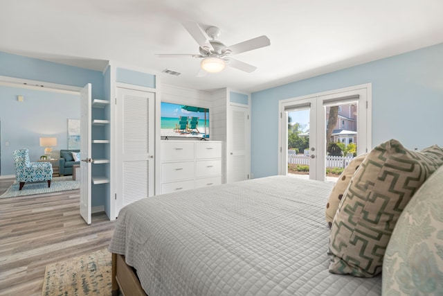 bedroom featuring ceiling fan, visible vents, access to exterior, french doors, and light wood-type flooring