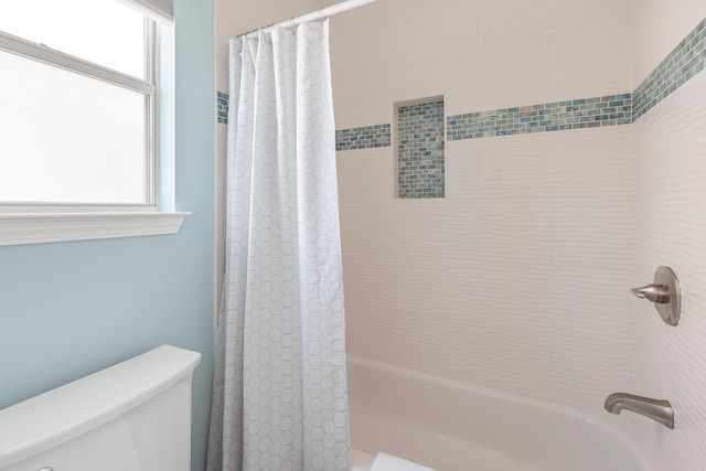 bathroom with toilet and shower / tub combo with curtain