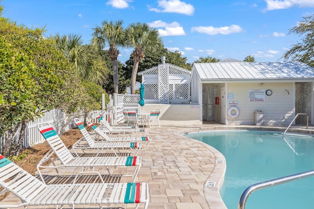 pool featuring fence and a patio