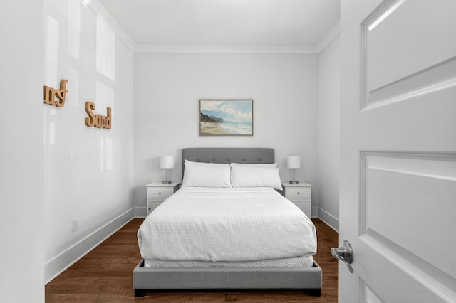 bedroom with dark hardwood / wood-style flooring and crown molding