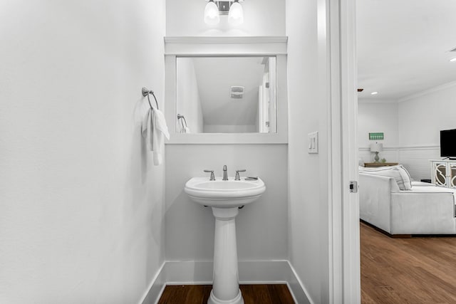 bathroom with crown molding and hardwood / wood-style floors