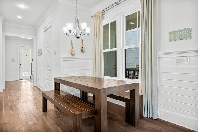 dining space with a notable chandelier, dark hardwood / wood-style flooring, and crown molding