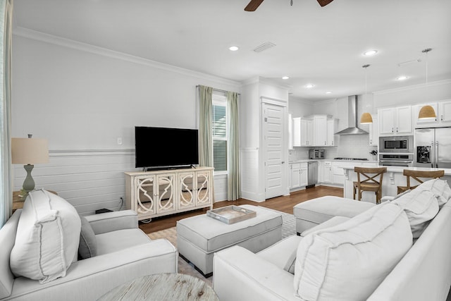 living room with crown molding and wood-type flooring