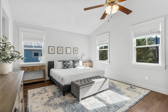 bedroom with lofted ceiling, dark wood-type flooring, and ceiling fan