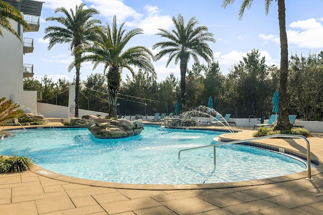 view of swimming pool with a patio and pool water feature