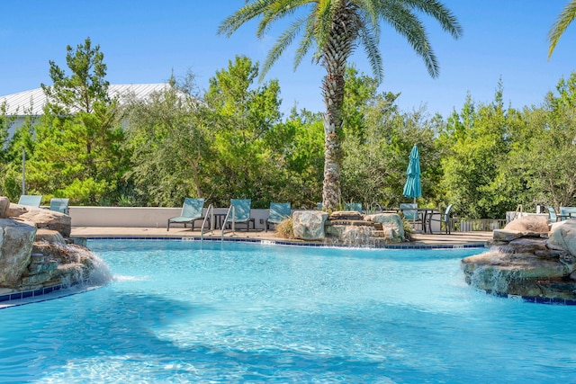 view of pool with pool water feature