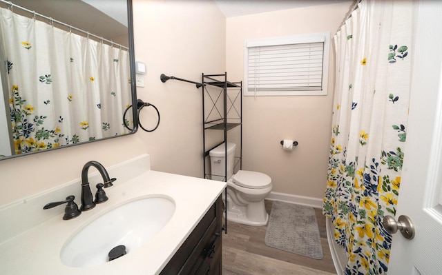 bathroom featuring hardwood / wood-style flooring, vanity, and toilet