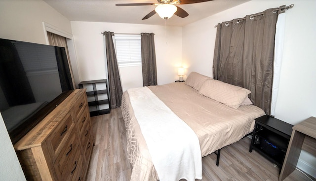 bedroom with ceiling fan and light wood-type flooring