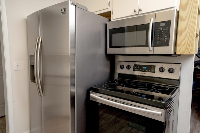 kitchen with appliances with stainless steel finishes and white cabinets