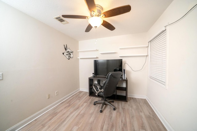 office space with ceiling fan and light hardwood / wood-style flooring