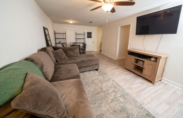 living room with ceiling fan and light hardwood / wood-style floors