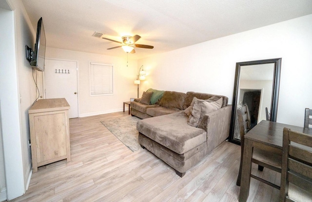 living room featuring ceiling fan and light wood-type flooring