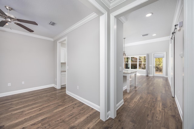 hall with a textured ceiling, dark hardwood / wood-style floors, and crown molding