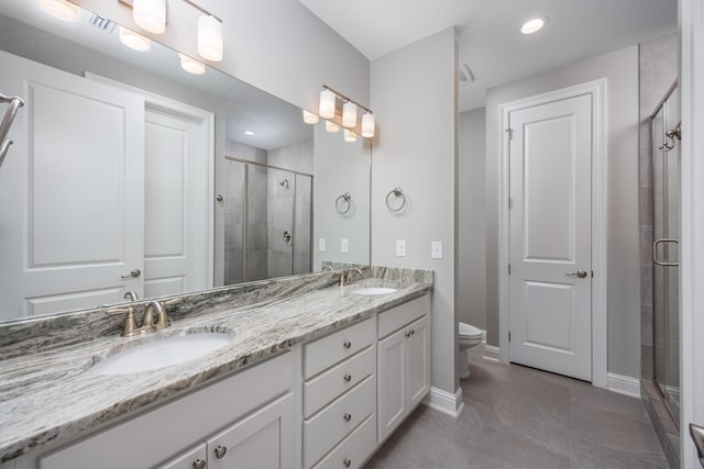 bathroom with tile patterned flooring, toilet, vanity, and walk in shower