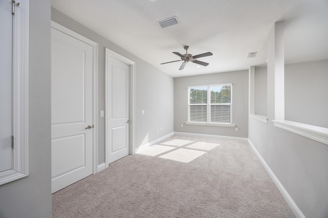 unfurnished bedroom with ceiling fan and light carpet