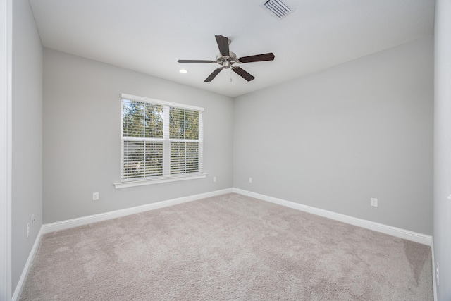 empty room with ceiling fan and light colored carpet