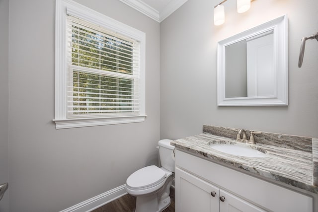 bathroom featuring wood-type flooring, vanity, toilet, and crown molding