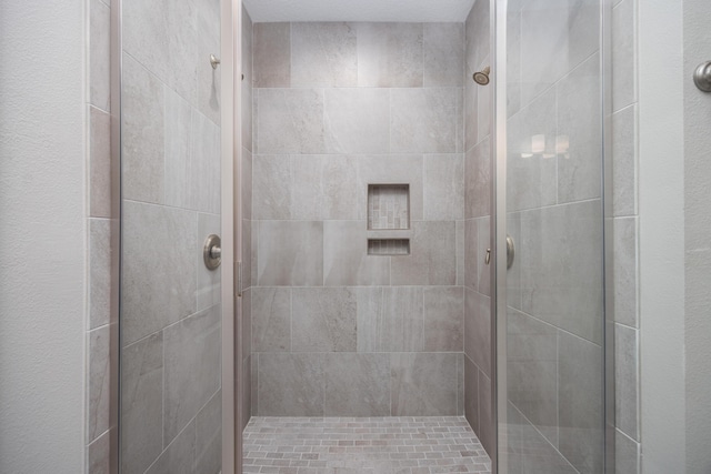 bathroom with a shower with door