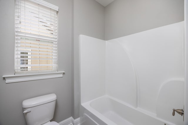 bathroom featuring shower / tub combination and toilet