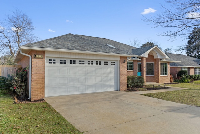 single story home featuring a front lawn and a garage