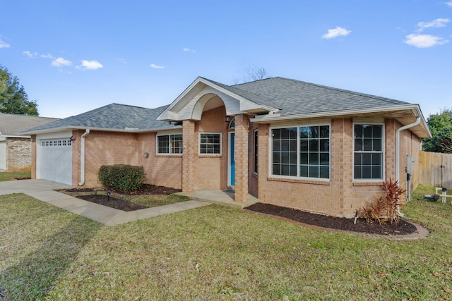 single story home featuring a front lawn and a garage