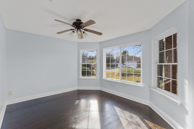 unfurnished room with dark hardwood / wood-style floors and ceiling fan