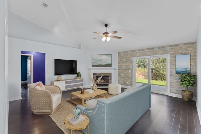 living room featuring dark hardwood / wood-style floors, vaulted ceiling, and ceiling fan