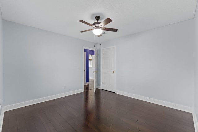 unfurnished room featuring ceiling fan and dark wood-type flooring