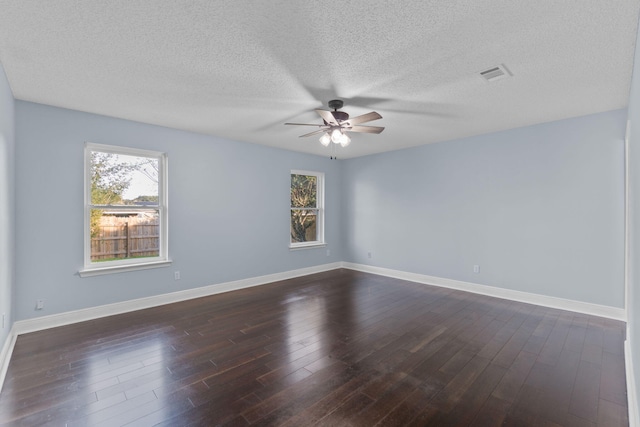 spare room featuring a textured ceiling, dark hardwood / wood-style floors, and ceiling fan