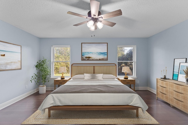 bedroom featuring a textured ceiling, ceiling fan, and dark wood-type flooring