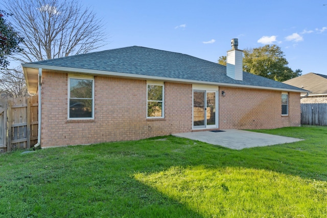 rear view of house with a yard and a patio area