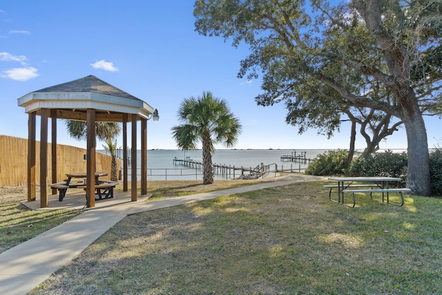 surrounding community with a gazebo, a water view, and a yard