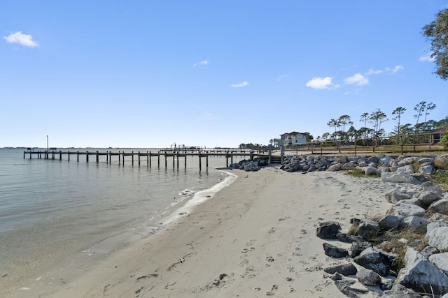 view of water feature with a dock and a beach view