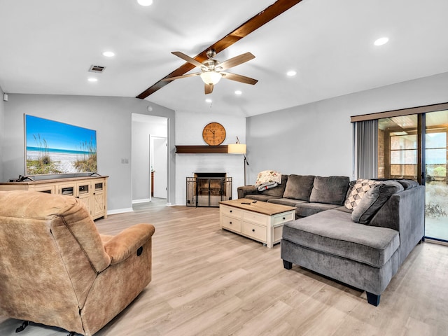 living room with ceiling fan, vaulted ceiling with beams, and light hardwood / wood-style floors