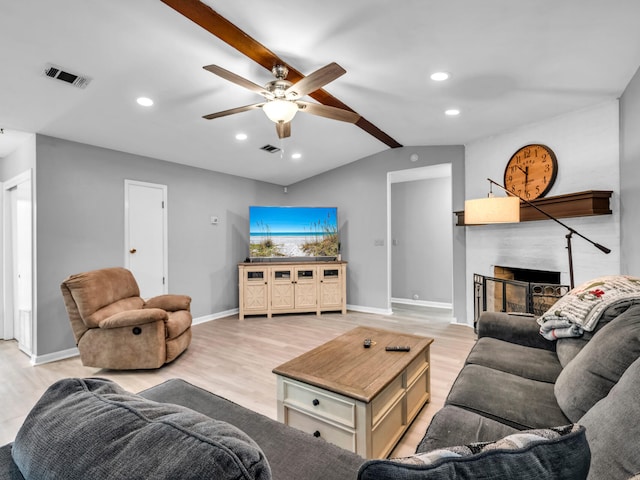 living room with vaulted ceiling, ceiling fan, and light wood-type flooring