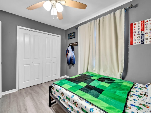 bedroom featuring ceiling fan, a closet, and light wood-type flooring