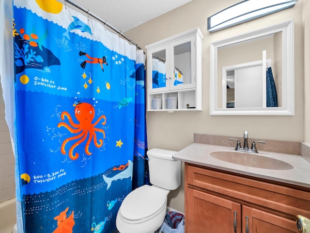 bathroom with a textured ceiling, toilet, and vanity