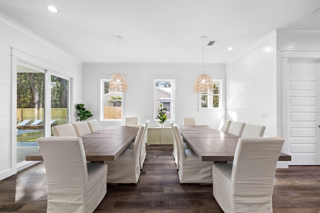 dining room featuring crown molding and dark wood-type flooring