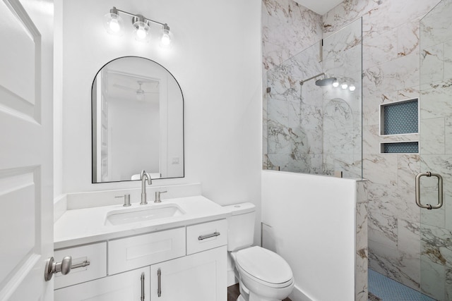 bathroom with vanity, toilet, and an enclosed shower