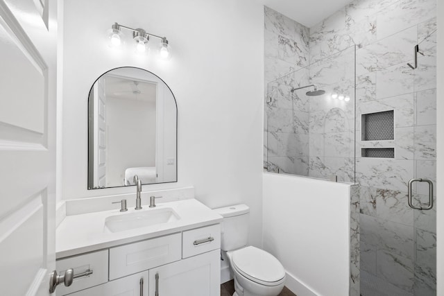 bathroom featuring vanity, toilet, and walk in shower