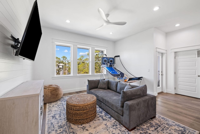 living room featuring ceiling fan and wood-type flooring