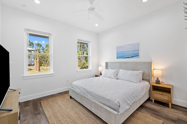 bedroom featuring multiple windows, ceiling fan, and dark hardwood / wood-style floors