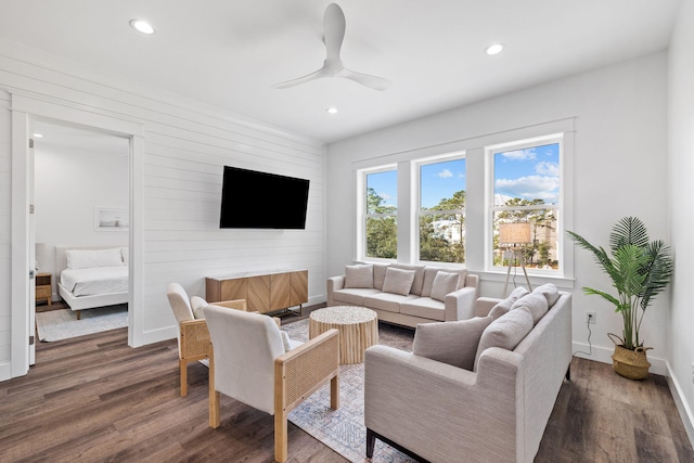 living room with ceiling fan and dark hardwood / wood-style flooring