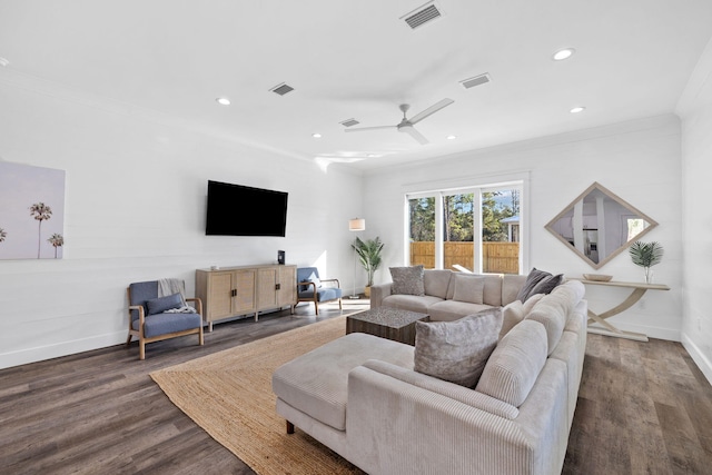 living room with ceiling fan, ornamental molding, and dark wood-type flooring