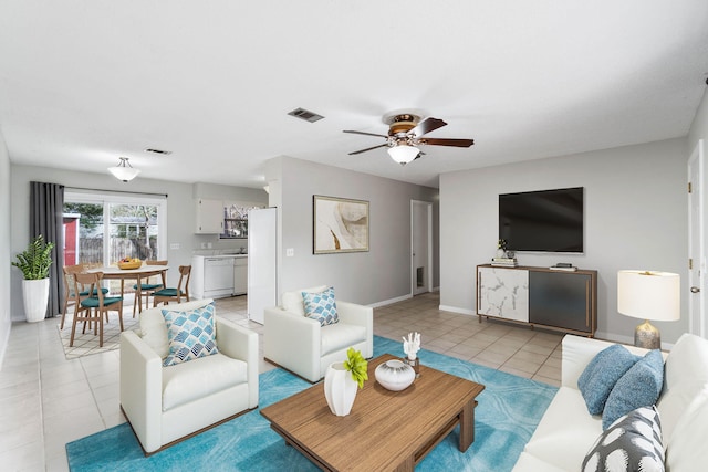 tiled living room featuring ceiling fan