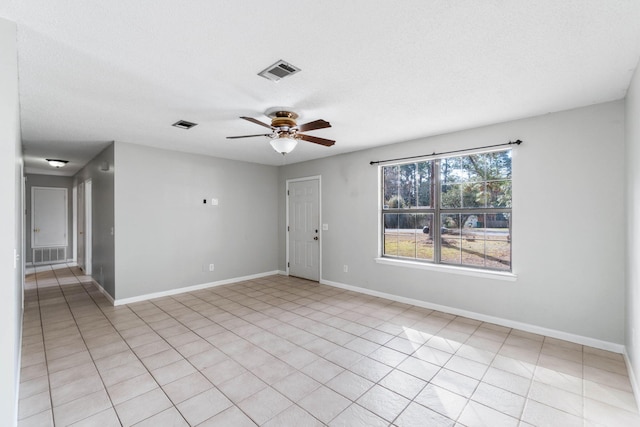 unfurnished room with a textured ceiling and ceiling fan