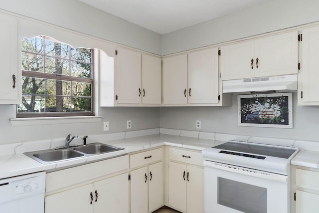 kitchen featuring white cabinetry, sink, and white appliances